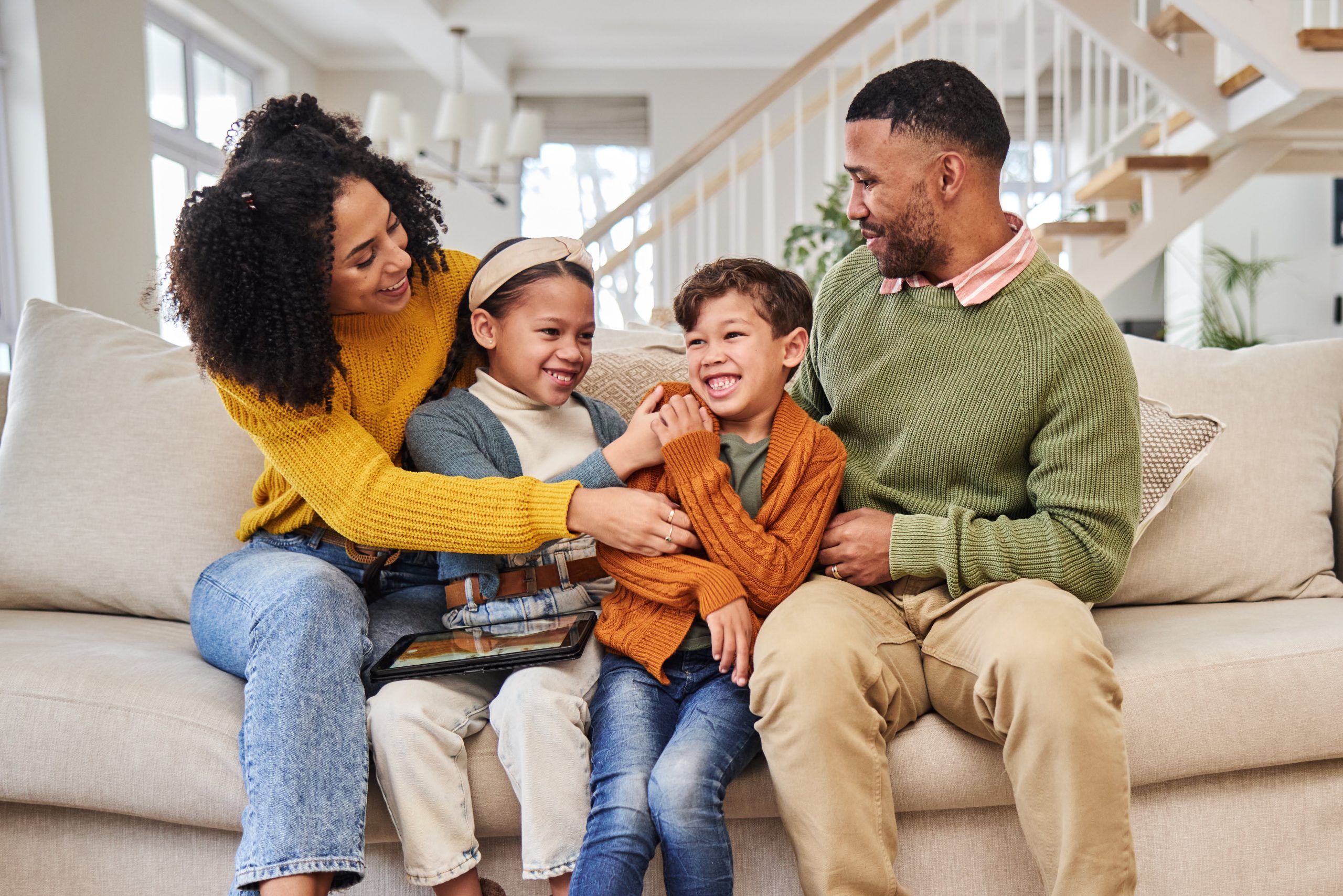 parents and two kids on couch