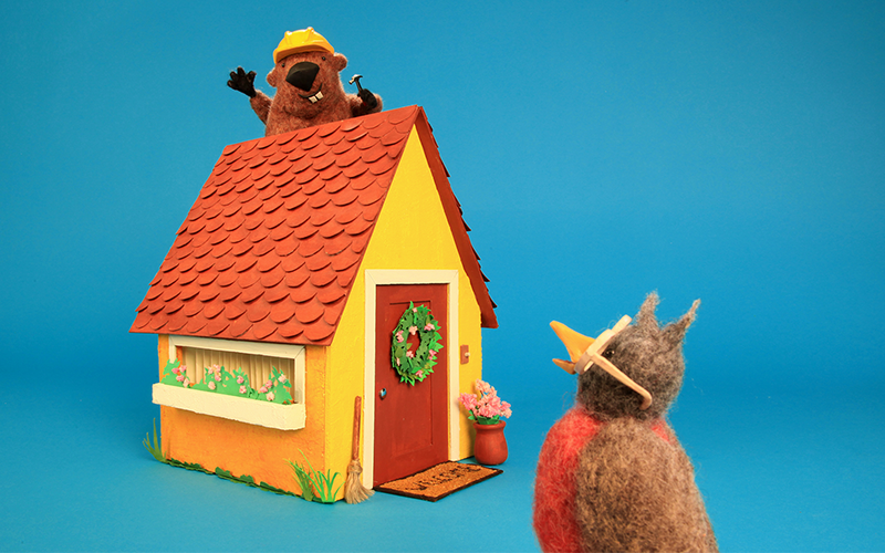 two animated characters by a house